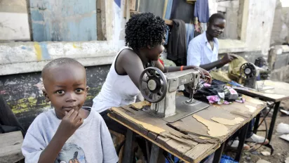 Working Woman with a kid in Africa.